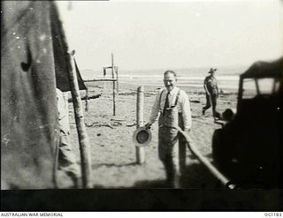 AITAPE, NORTH EAST NEW GUINEA. C. 1944-06. ARTHUR DRAKEFORD, THE MINISTER FOR AIR, ON THE BEACH ADJOINING THE RAAF CAMP DURING A VISIT TO RAAF UNITS IN THE NEW GUINEA AREA