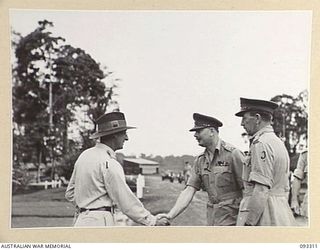 LAE AREA, NEW GUINEA, 1945-06-28. HIS ROYAL HIGHNESS. THE DUKE OF GLOUCESTER, GOVERNOR-GENERAL OF AUSTRALIA (2) BEING GREETED BY MAJ M.W. GINSBERG (1) ON ARRIVAL AT 112 CONVALESCENT DEPOT. BRIG ..