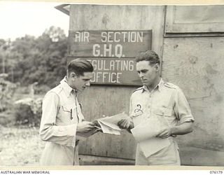 FINSCHHAFEN, NEW GUINEA. 1944-09-20. Q151501 PRIVATE K. AUSTIN (1), AND NX53049 CORPORAL O.I. SHEPHERD (2), MEMBERS OF THE AIR SECTION, GENERAL HEADQUARTERS REGULATING OFFICE EXAMINING PAPERS AT ..