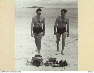 PORT MORESBY, PAPUA, 1944-02. CRAFTSMAN IAN DANGLEISH, AN AUSTRALIAN SOLDIER, WITH WILLIAM A. REID, OF CHICAGO, ILLINOIS, AN AMERICAN OFFICER, RETURNING FROM A SWIM