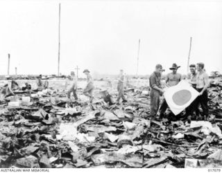 Alexishafen, New Guinea. 1944-04. Australian troops amid the wreckage of Alexishafen