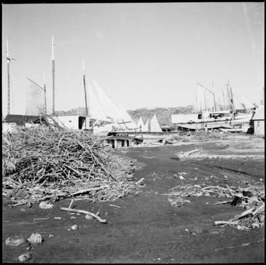 Small boats with sails set and five two masted vessels on the beach, Rabaul Harbour, New Guinea, 1937 / Sarah Chinnery