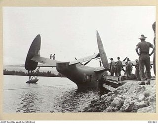 PALMALMAL PLANTATION, NEW BRITAIN, 1945-06-23. A MARTIN MARINER FLYING BOAT OF THE RAAF BEING SECURED TO THE JETTY PRIOR TO DISEMBARKATION OF ADVANCED PARTY OF HQ 11 DIVISION, ARRIVING FROM ..