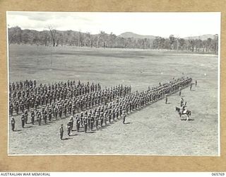 WONDECLA, QLD. 1944-04-15. GENERAL VIEW OF THE PARADE OF THE 2/1ST INFANTRY BATTALION, IN CLOSE COLUMN, STANDING AT ATTENTION, ON THE HERBERTON RACECOURSE. TAKING THE PARADE IS THE COMMANDING ..