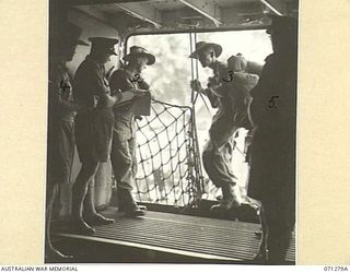 MILNE BAY, PAPUA, 1944-03-17. NX27518 LIEUTENANT A.B.R. MILLER (1), THE SHIP'S ADJUTANT, PICTURED ORGANISING THE EMBARKATION OF TROOPS ONTO H.T. TAROONA FOR HOME LEAVE TO AUSTRALIA. SHOWN ARE: A ..
