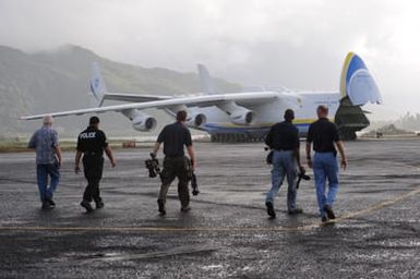 Earthquake ^ Flooding ^ Tsunami - Pago Pago, American Samoa, October 13, 2009 -- From right to left, Dennis Coliten (FEMA), an American Samoa police officer, Casey De Shong (FEMA), Ken Tingman (FEMA) and Gerard Stolar (FEMA) walk across the tarmac to greet the Antonov AN-225 cargo plane. The cargo plane is the largest in the world and carried generators contracted by the Federal Emergency Management Agency to assist the island with electrical power restoration. David Gonzalez/FEMA