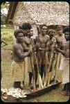 Men mashing up taro root