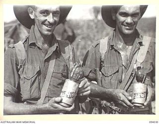 WEWAK AREA, NEW GUINEA, 1945-07-14. SAPPER E.M. FORSBERG, 2/14 FIELD COMPANY, ROYAL AUSTRALIAN ENGINEERS, ATTACHED 2/8 INFANTRY BATTALION (1) AND SAPPER R.C. JACKSON, 2/14 FIELD COMPANY (2), ..