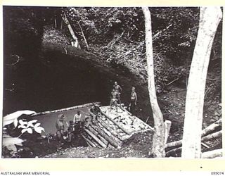 GAZELLE, NEW BRITAIN. 1945-11-23. JAPANESE TROOPS CONSTRUCTED A PRISONER OF WAR CAMP UNDER THE SUPERVISION OF 13 FIELD COMPANY. SHOWN, WORKING PARTY CONSTRUCTING A DAM FOR SUPPLYING THE CAMP WITH ..