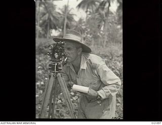 AITAPE, NORTH EAST NEW GUINEA. C. 1944-06. LOOKING THROUGH THE THEODOLITE, LIGHT LIEUTENANT J. G. MCGUIRE, WHO, AS A FORMER MAYOR OF ROCKDALE, NSW, AND PRESIDENT OF THE ROCKDALE RAAF RECRUITING ..