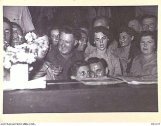 LAE AREA, NEW GUINEA, 1945-06-13. GATHERED AROUND THE PIANO FOR A SING-SONG DURING A DINNER AND DANCE HELD BY NO. 2 OTHER RANKS' MESS, HQ FIRST ARMY