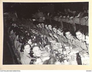 TOROKINA, BOUGAINVILLE. 1945-07-02. A GROUP OF AUSTRALIAN ARMY NURSING SERVICE SISTERS IN THE SISTERS' MESS, 2/1 GENERAL HOSPITAL DURING A FORMAL DINNER CELEBRATING THE 43RD ANNIVERSARY OF THE ..