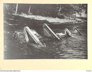 1942-10-01. NEW GUINEA. MILNE BAY. SUNKEN LANDING BARGES USED AT MILNE BAY, WHERE AUSTRALIAN FORCES FRUSTRATED THE JAPANESE ATTEMPTS TO LAND