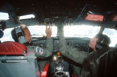 Pilot CPT Kurt Lajala, left, and co-pilot 1LT Steve Hazelfeldt check some of the instruments in the cockpit of a KC-135 Stratotanker aircraft during a flight out of Andersen Air Force Base, Guam, during exercise Giant Warrior '89. The two officers are members of the 906th Air Refueling Squadron