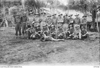 SAKULA, NEW GUINEA. 1944-08-05. A GROUP OF EUROPEAN OFFICERS AND NON COMMISSIONED OFFICERS OF A COMPANY, PAPUAN INFANTRY BATTALION AFTER THE UNIT HAD BEEN WITHDRAWN FROM THE SEPIK RIVER DISTRICT. ..