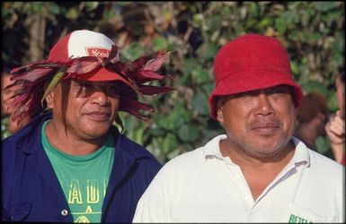 Two men wearing red hats