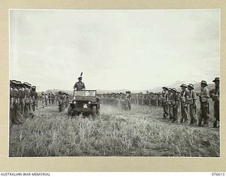 WAWIN, MARKHAM VALLEY, NEW GUINEA. 1944-10-24. NX4 BRIGADIER B.E. KLEIN, COMMANDER ROYAL ARTILLERY, INSPECTING MEMBERS OF THE ROYAL AUSTRALIAN ARTILLERY UNITS OF THE 3RD DIVISION