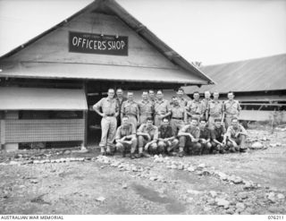LAE, NEW GUINEA. 1944-09-22. MEMBERS OF THE STAFF OUTSIDE THE OFFICERS' SHOP, HEADQUARTERS NEW GUINEA FORCE. IDENTIFIED PERSONNEL ARE:- VX73565 CORPORAL H.S. WATSON (1); VX58950 CORPORAL D.H. ..