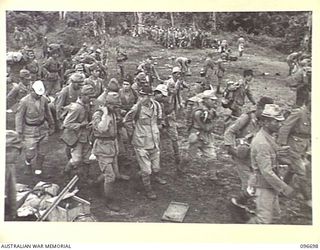KAIRIRU ISLAND, NEW GUINEA. 1945-09-17. JAPANESE NAVAL PERSONNEL MOVING TOWARDS BARGE POINTS FOR TRANSFER TO MUSCHU ISLAND. THEIR GEAR HAS BEEN SEARCHED BY MILITARY POLICE AND FIELD SECURITY ..