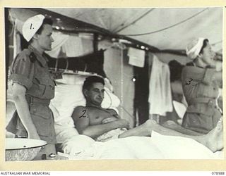 BOUGAINVILLE ISLAND. 1945-01-23. QFX23684 SISTER J. BYRES (1) AND QFX43182 SISTER L.M. KAVNEY (3) PREPARING TO GIVE TREATMENT TO A PATIENT AT THE 2/1ST AUSTRALIAN GENERAL HOSPITAL