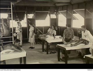 Port Moresby, New Guinea. 1944-05-09. The interior of the main ward of the Physiotherapy Department, 128th Australian General Hospital. Left to right: VX140786 Sapper Duncan; NX176045 Private ..