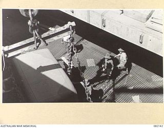 TOWNSVILLE, QLD. 1944-10-18. TRANSPORT VEHICLES OF FIRST ARMY BEING LOADED INTO HOLDS ABOARD THE LIBERTY SHIP SS JAMES OLIVER DURING EMBARKATION TO LAE, NEW GUINEA