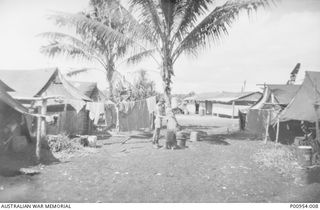 INLAND FROM PORT MORESBY, NEW GUINEA. 1943-11. UNIT NO 1 WIRELESS UNIT RAAF. JAPANESE KANA WIRELESS INTERCEPT OPERATORS' CAMP SITE. AN UNKNOWN OPERATOR IS WASHING CLOTHES. THE WIRELESS ROOM ..