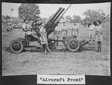 Members of the Tonga Defence Force of 2nd NZEF, learning how to operate an anti-aircraft gun, in Tonga