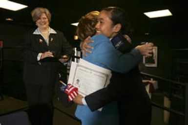 Cadet Candidate Mercy Teo(cq), 18, from American Samoa, right, (she's in Dick Foster's story) hugs Ellen Cesarone (cq), assistant to U.S. Congressman Joel Hefley, after Teo was sworn in as a new U.S. citizen at Ft. Carson in Colorado Springs on April 22