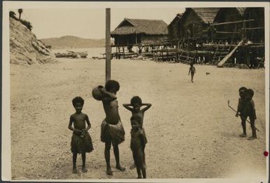 Elevala village children standing on a beach, Port Moresby, Papua, ca. 1923, 1 / Sarah Chinnery