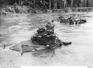 BOUGAINVILLE. 1945-03-30. MATILDA TANKS OF B SQUADRON, 2/4 ARMOURED REGIMENT, CROSSING THE PURIATA RIVER DURING THE MOVE FORWARD TO SUPPORT 25 INFANTRY BATTALION. THE BULLDOZERS IN THE BACKGROUND ..