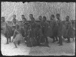 Men and boys posing near building