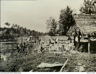 Aitape, New Guinea. 1945-01. The Sisters' Mess (right foreground) and their tent lines at the 2/11th Australian General Hospital (2/11AGH) by the side of the Aitape River. In an area prone to ..