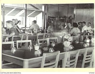 PORT MORESBY, PAPUA, 1944-02-20. MEMBERS OF THE AUSTRALIAN ARMY MEDICAL WOMEN'S SERVICE AND ESCORTS ENJOYING AFTERNOON TEA IN THE DINING ROOM OF THE AUSTRALIAN WOMEN'S SERVICES CLUB, CONDUCTED BY ..