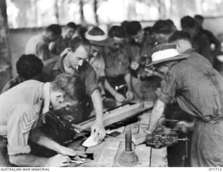 LAE, NEW GUINEA, 1944-03-25. PATIENTS AT WORK IN THE HOBBY HUT AT THE 112TH CONVALESCENT DEPOT DURING THE OCCUPATIONAL THERAPY PERIOD. IDENTIFIED PERSONNEL ARE: WX2015 SERGEANT F. NAILLARD, REAR ..