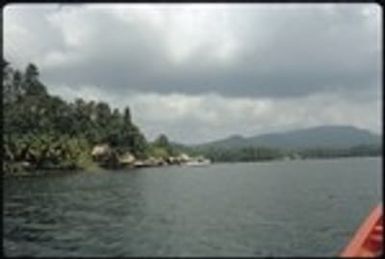 View of houses on the shoreline from a boat