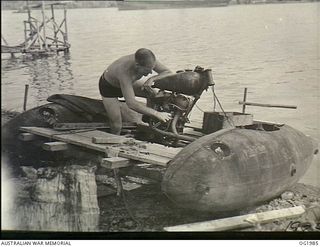 MADANG, NEW GUINEA. C. 1945-01. SALVAGED EQUIPMENT IS PUT TO A NUMBER OF INGENIOUS USES. IN THIS CASE AN OLD MOTOR CYCLE ENGINE ATTACHED TO TWO KITTYHAWK AIRCRAFT BELLY TANKS HAS MADE A SPEEDY ..