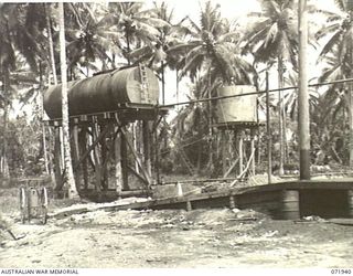 MILNE BAY, PAPUA, NEW GUINEA. 1944-04-03. A 12,000 GALLON TANK IN THE FOREGROUND. THE TANKS ARE AMONG SEVERAL IN USE AT THE 2ND BULK PETROLEUM STORAGE COMPANY