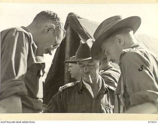 MADANG, NEW GUINEA. 1944-04-27. SENIOR OFFICERS DISCUSSING CAMPAIGN PLANS AT HEADQUARTERS 8TH INFANTRY BRIGADE. IDENTIFIED PERSONNEL ARE:- NX112699 CAPTAIN J.F. BUTLER, 8TH INFANTRY BRIGADE (1); ..