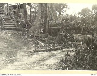 NONGARA, FINSCHHAFEN AREA, NEW GUINEA. 1944-03-13. ONE OF MANY BATTLE SIGNS IN THE FINSCHHAFEN AREA, THIS SIGN RECORDS ACTIVITIES OF THE 2/15TH INFANTRY BATTALION