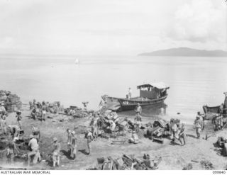 RABAUL, NEW BRITAIN, 19 FEBRUARY 1946. JAPANESE TROOPS LOADING BARGES WITH AMMUNITION IN PREPARATION FOR DUMPING OUT TO SEA. DUMPING OPERATIONS OF JAPANESE AMMUNITION AND EXPLOSIVES WERE CARRIED ..