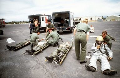 Medical personnel attend to "injured" crewman and firefighters during a space shuttle emergency landing exercise