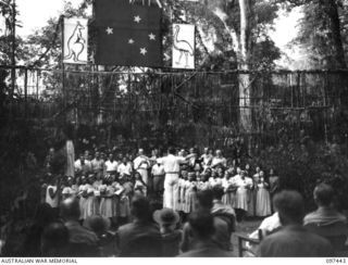 RAMALE VALLEY, NEW BRITAIN. 1945-10-02. THE FULL CHOIR OF NUNS AND NATIVES SINGING THEIR OWN COMPOSITION "SONS OF AUSTRALIA" AT THE CONCERT STAGED AS A THANKSGIVING FOR LIBERATION AT RAMALE ..