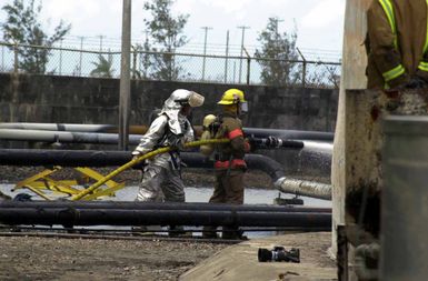 US Air Force (USAF) AIRMAN First Class (A1C) Billy Weinstein with the 36th Civil Engineer Squadron (CES), Fire Protection Flight stationed at Andersen Air Force Base (AFB), Guam, works to extinguish a fuel tank fire