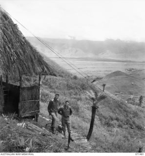 RAMU VALLEY, NEW GUINEA, 1944-03-27. NX17 MAJOR B.H. TRAVERS, OBE, BRIGADE MAJOR (1); WITH VX14737 CAPTAIN G.A. WILLIAMS, SIGNAL OFFICER (2), AT HEADQUARTERS, 15TH INFANTRY BRIGADE. A PANORAMA OF ..