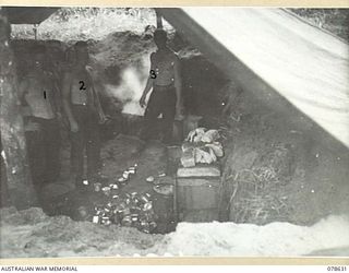 BOUGAINVILLE ISLAND. 1945-01-18. COOKS OF THE 42ND INFANTRY BATTALION PREPARING A MEAL FOR THE TROOPS IN THEIR HASTILY CONSTRUCTED KITCHEN. IDENTIFIED PERSONNEL ARE:- NX175589 STAFF SERGEANT J. ..