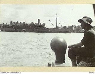 MADANG, NEW GUINEA. 1944. THE COURIER BARGE OF THE 593RD UNITED STATES BARGE COMPANY PASSING A RAN VESSEL AS SHE MAKES HER RUN UP THE HARBOUR