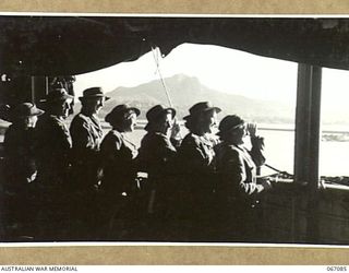 TOWNSVILLE, QLD. 1944-06-27. MEMBERS OF THE AUSTRALIAN ARMY MEDICAL WOMEN'S SERVICE WAITING TO DISEMBARK FROM THE H.M.T. "ORMISTON" ON THEIR ARRIVAL FROM NEW GUINEA. IN THE BACKGROUND CAN BE SEEN ..