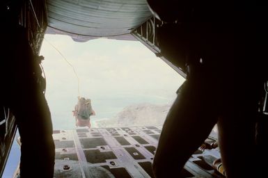 A combat control team member makes a static line jump from an aircraft