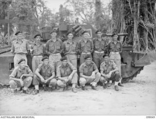 Group portrait of the personnel of No. L Troop, A Squadron, 2/4th Armoured Regiment. Left to right, back row: NX80575 Corporal (Cpl) W G C Smith of West Ryde, NSW; NX9993 Sergeant (Sgt) J D MacLeay ..